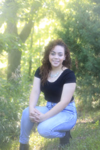 senior sits in the greenery