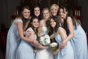 Bridesmaids surround bride at wedding