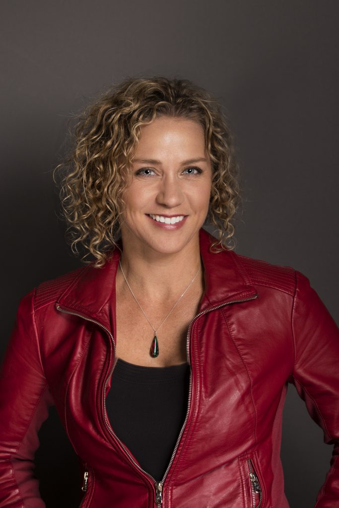 Woman with curly hair and red jacket