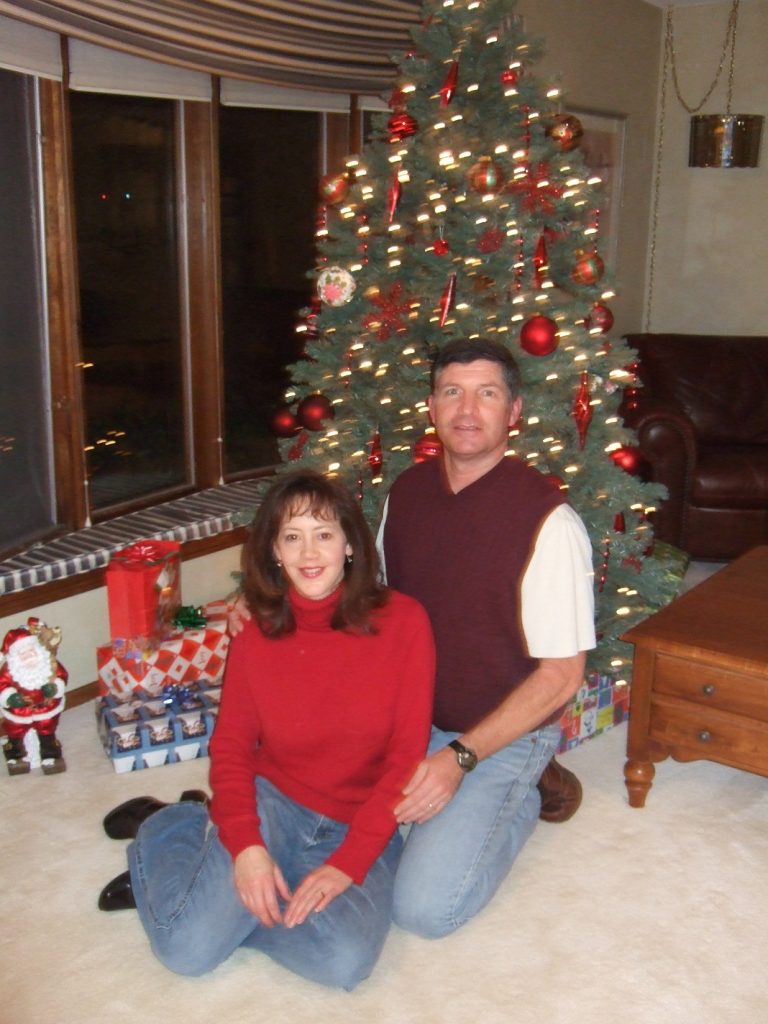 Tony and Lori in front of the Christmas tree