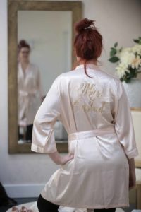 Bride looks at herself in mirror