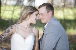 bride and groom put face together