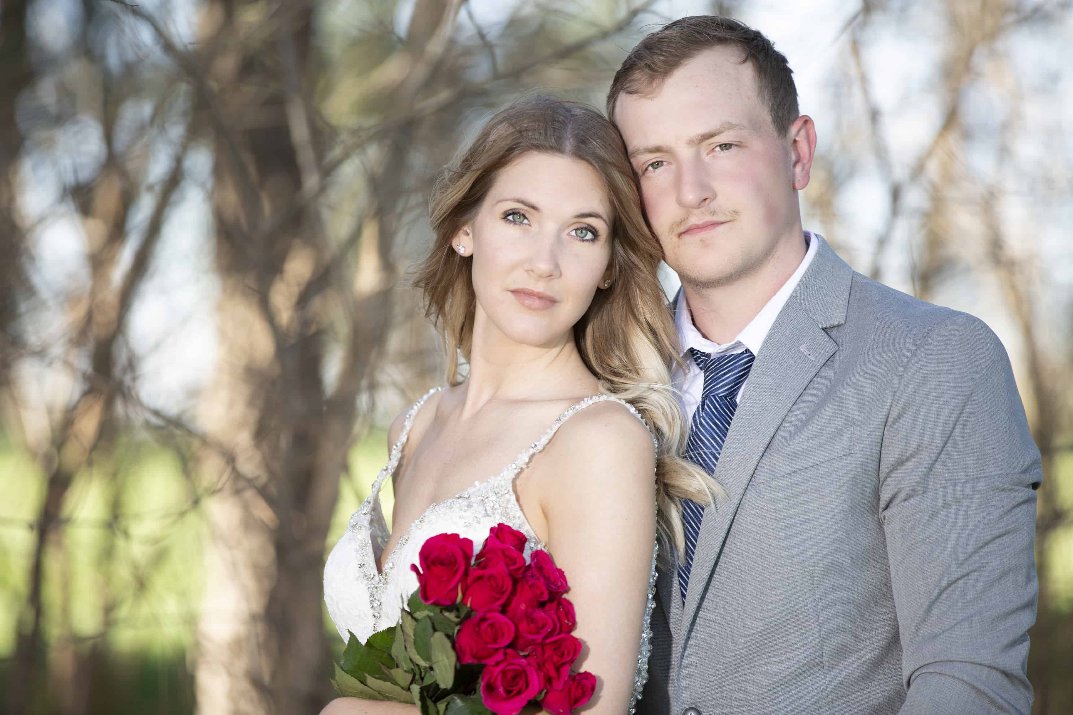 Bride and groom look at the camera