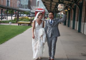 bride and groom walk through the Haymarket