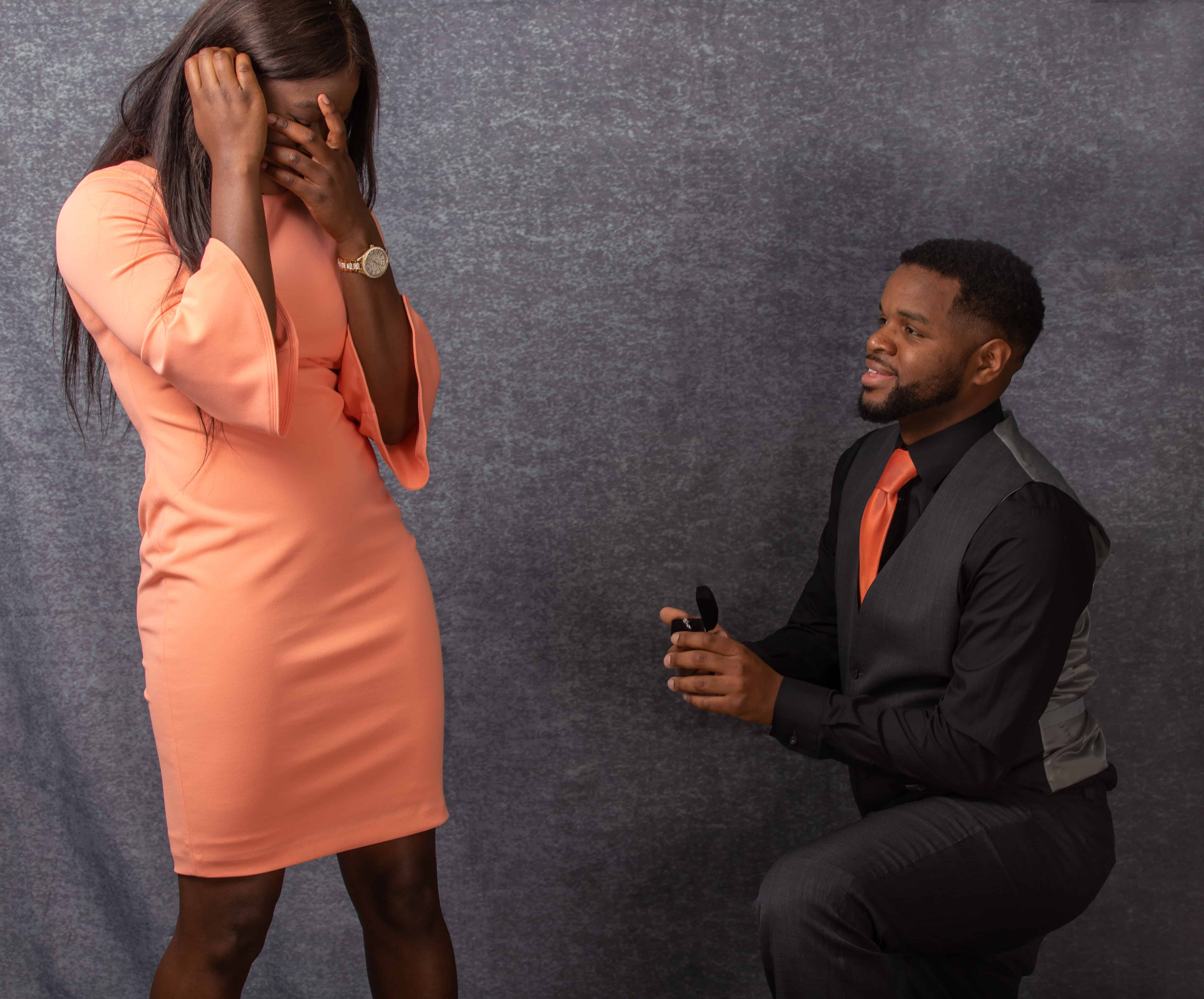 Man on one knee shows ring to girlfriend