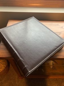 brown leather wedding album on a table
