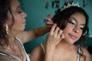 mother helps daughter prepare for quinceanera