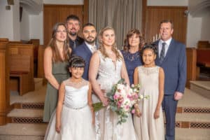 bride and groom in full family photo