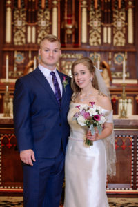bride and groom pose in the sanctuary