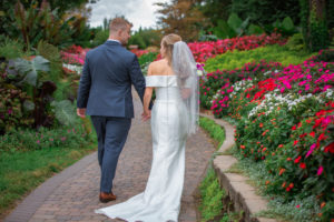 backs of bride and groom walking