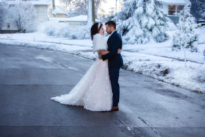bride and groom on a snowy street