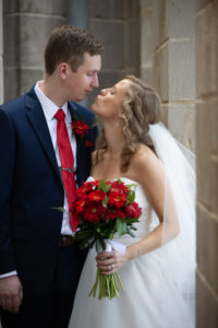 bride reaches for a kiss with her groom