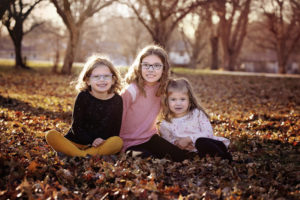 Three sisters pose in the leaves