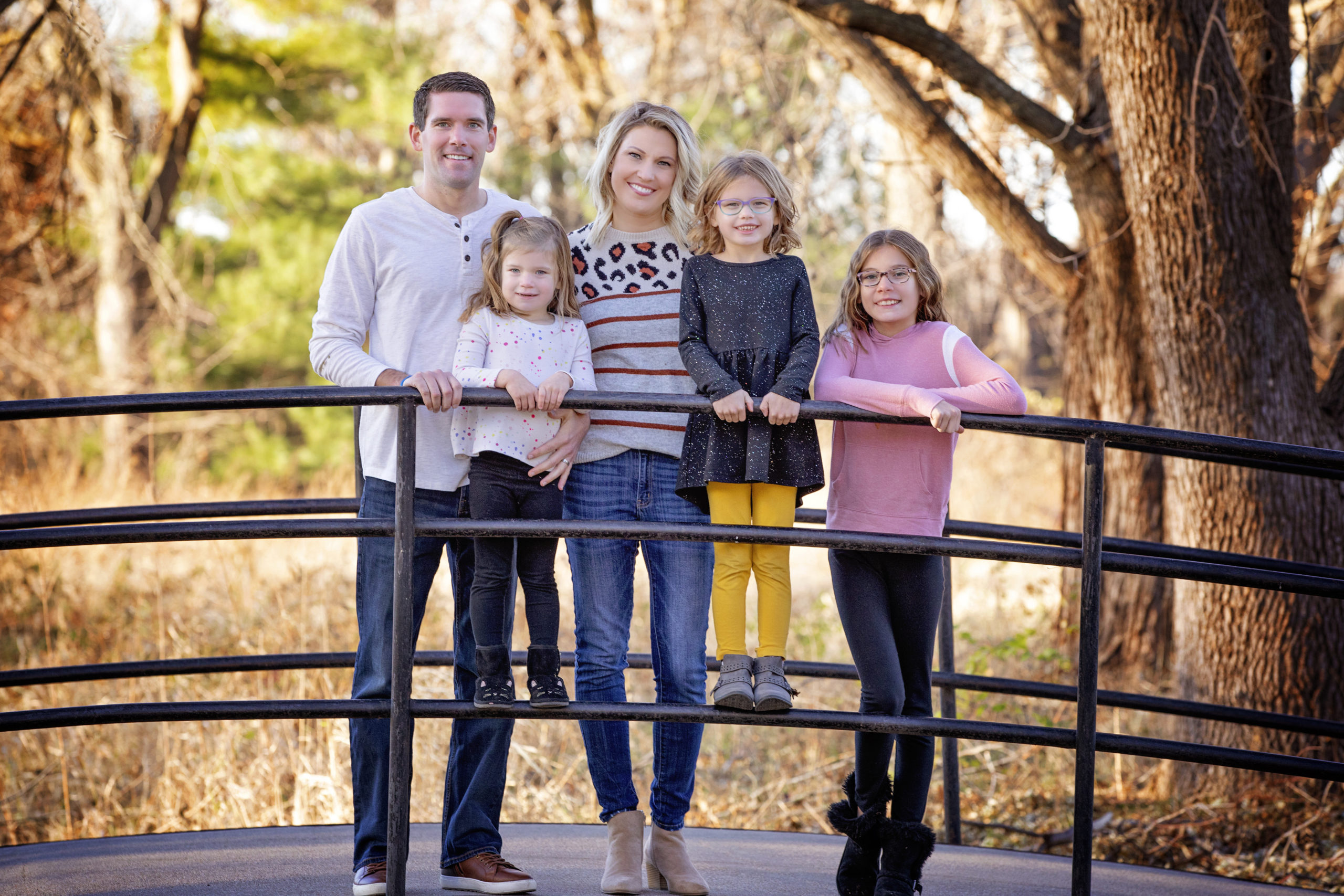 Family poses on bridge