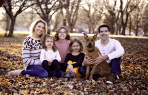Family poses with their dog