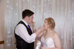 bride and groom eat cake