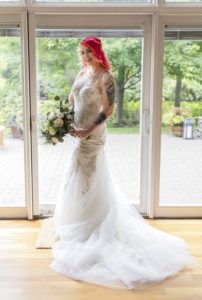 bride poses in front of sliding glass door
