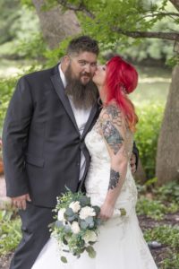 bride kisses groom on the cheek