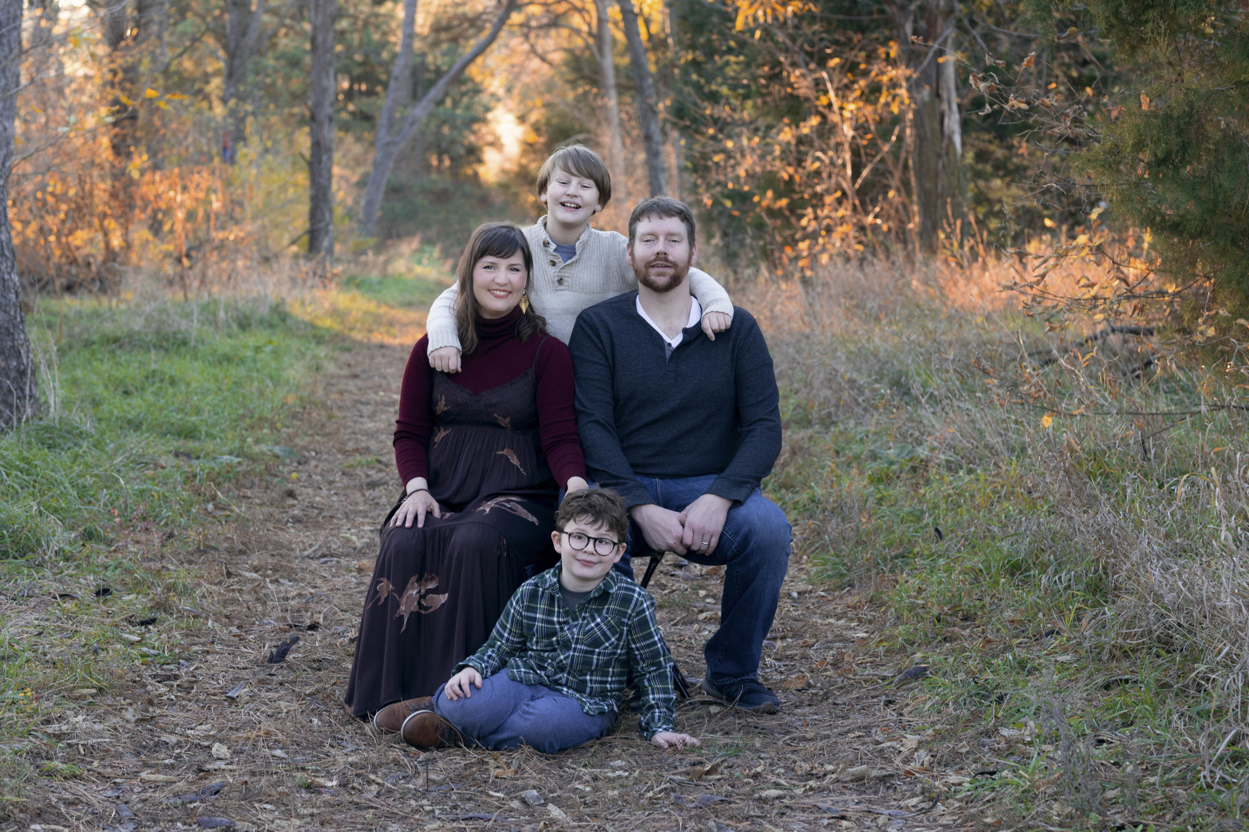 Parents sit while kids are on ground and standing behind