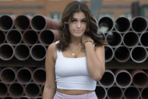 Posing in front of metal tubes