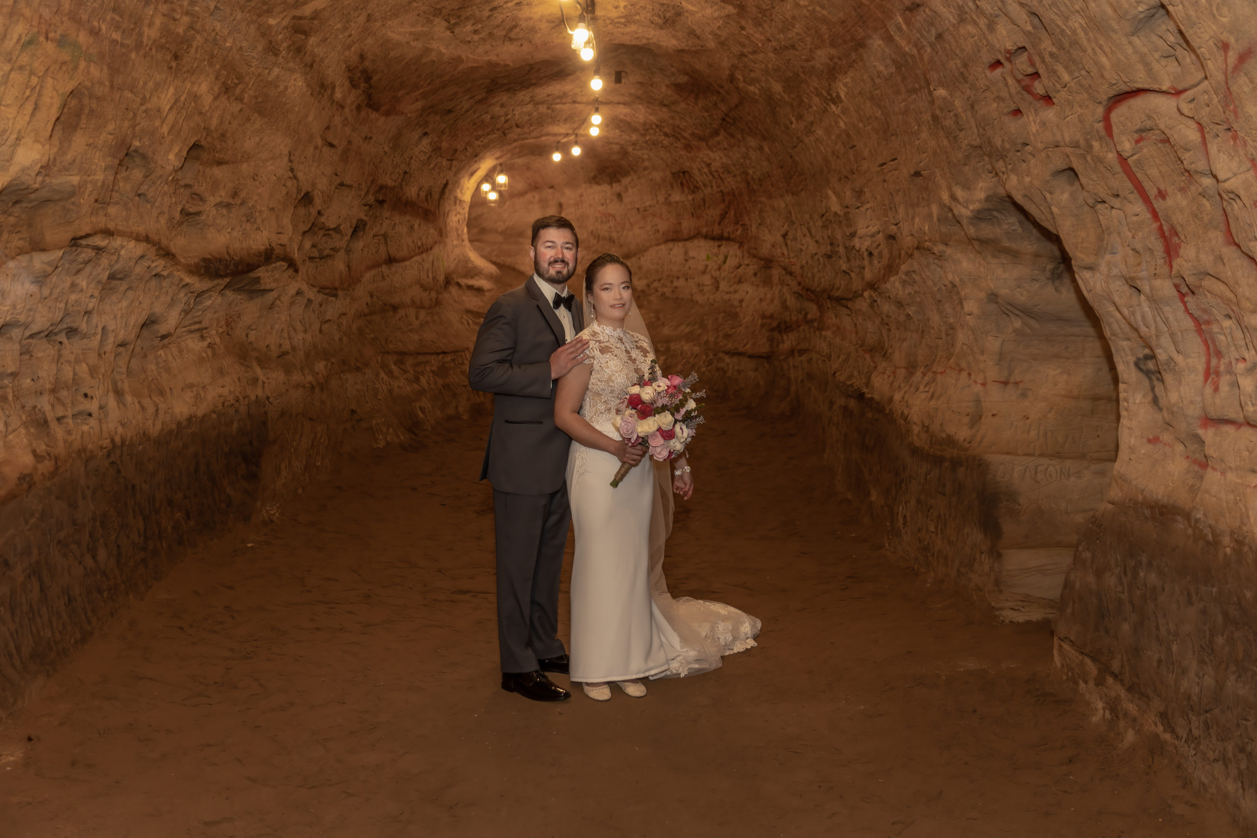 bride and groom in Robber's Cave hallway
