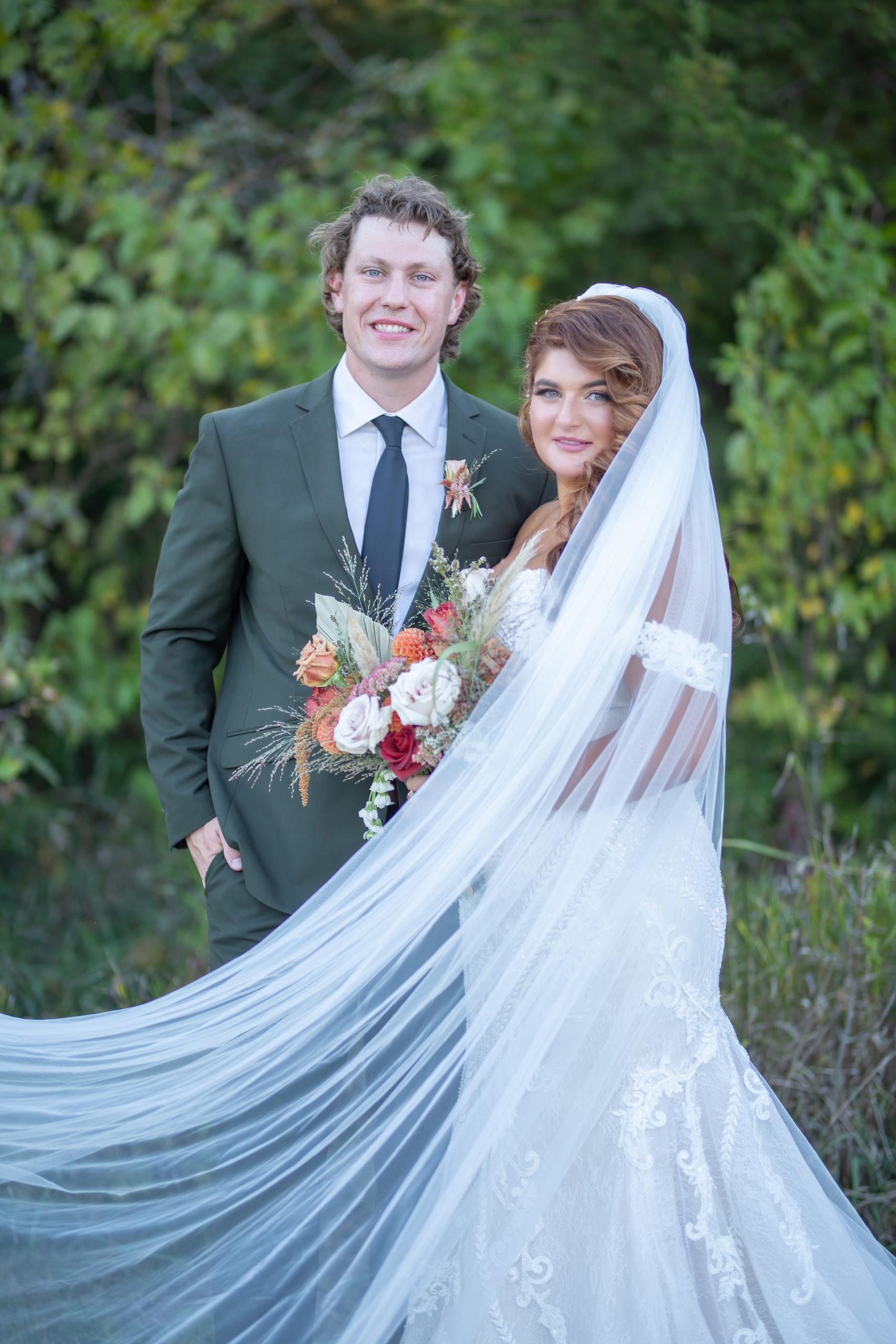 bride and groom with the bride's veil flying