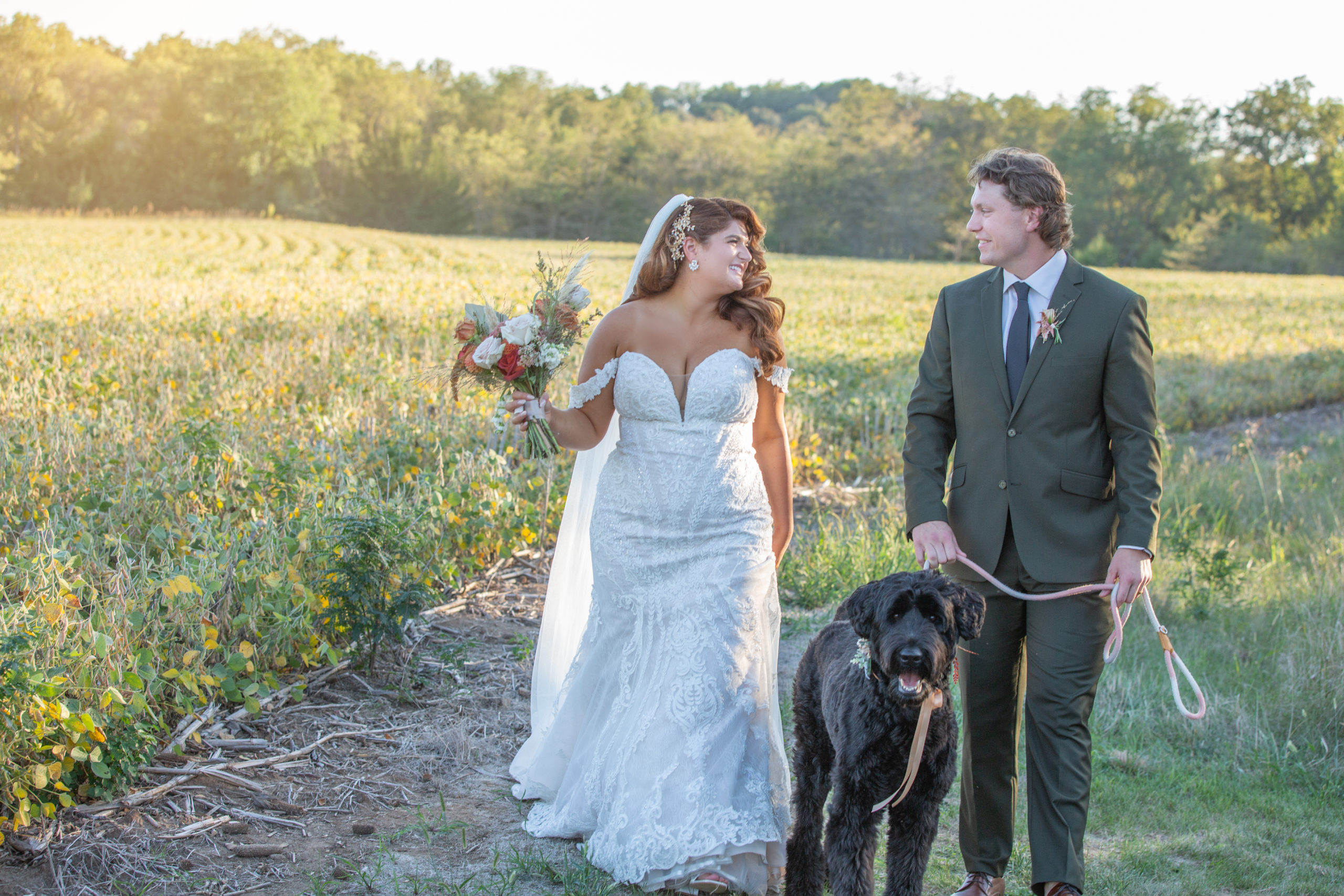 bride and groom walking hand in hand with their dog at Slattery Vintage Estates Wedding