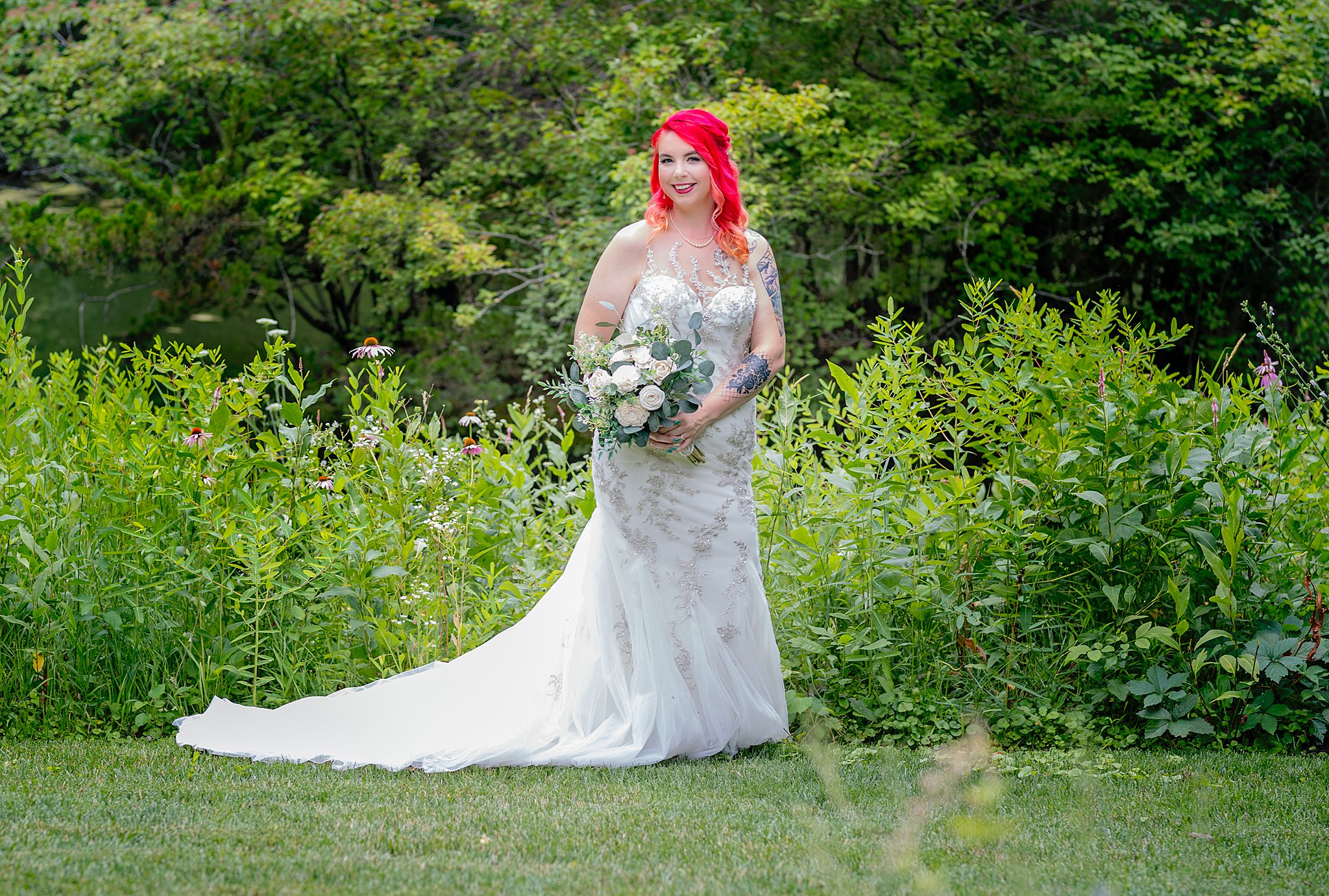bride with long train, pink hair, and bouquet at her mahoney state park wedding