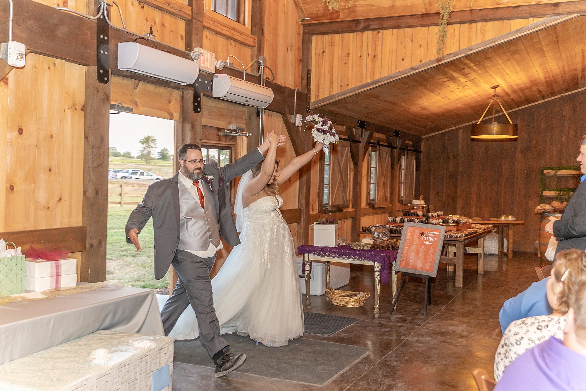 Newlyweds enter their barn reception roca berry farm wedding