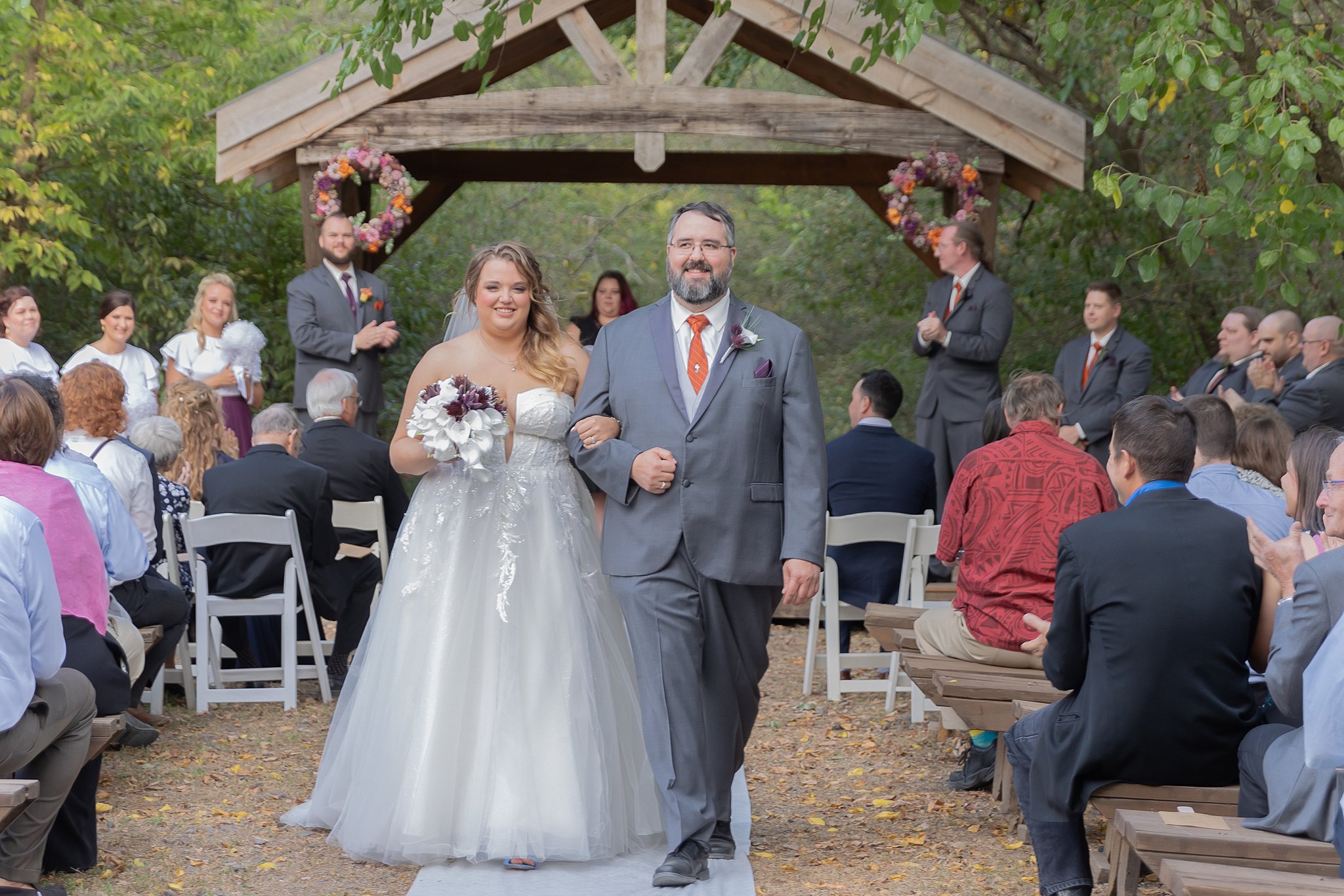 newlyweds walk down the aisle together after ceremony roca berry farm wedding