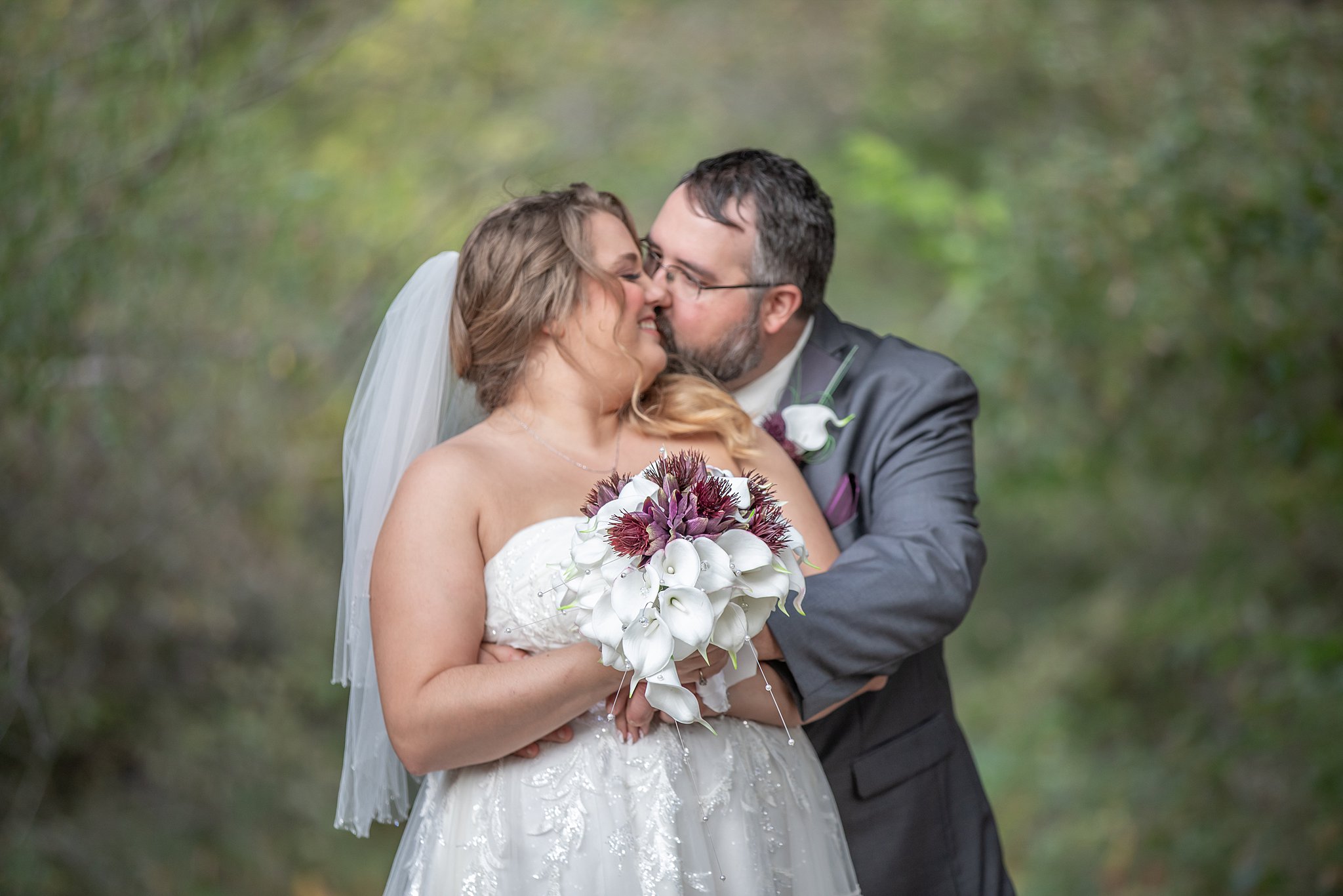 newlyweds kiss in the forest roca berry farm wedding