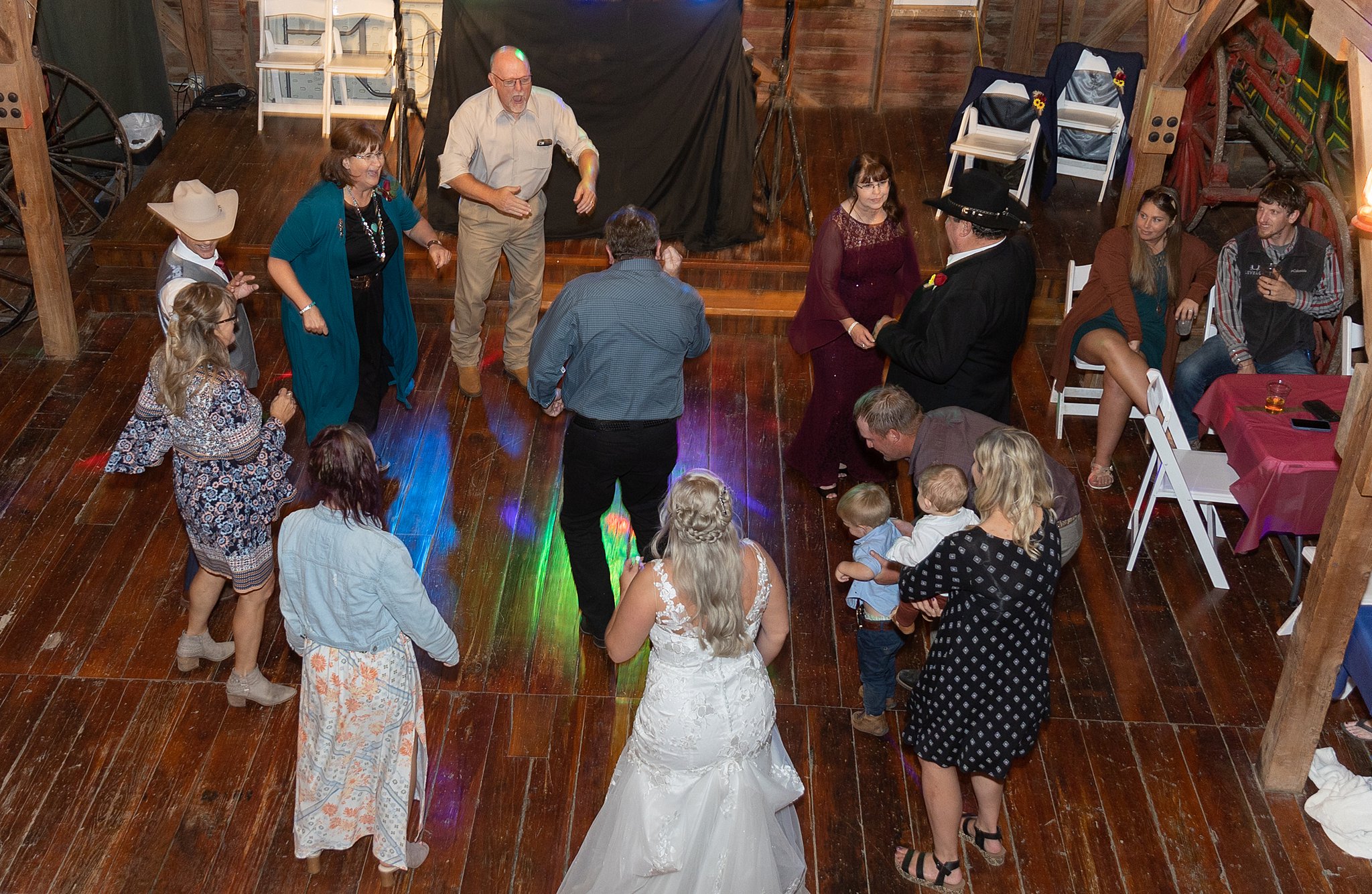 A bride dances in a circle with her guests inside a barn at a great wedding reception venues lincoln ne