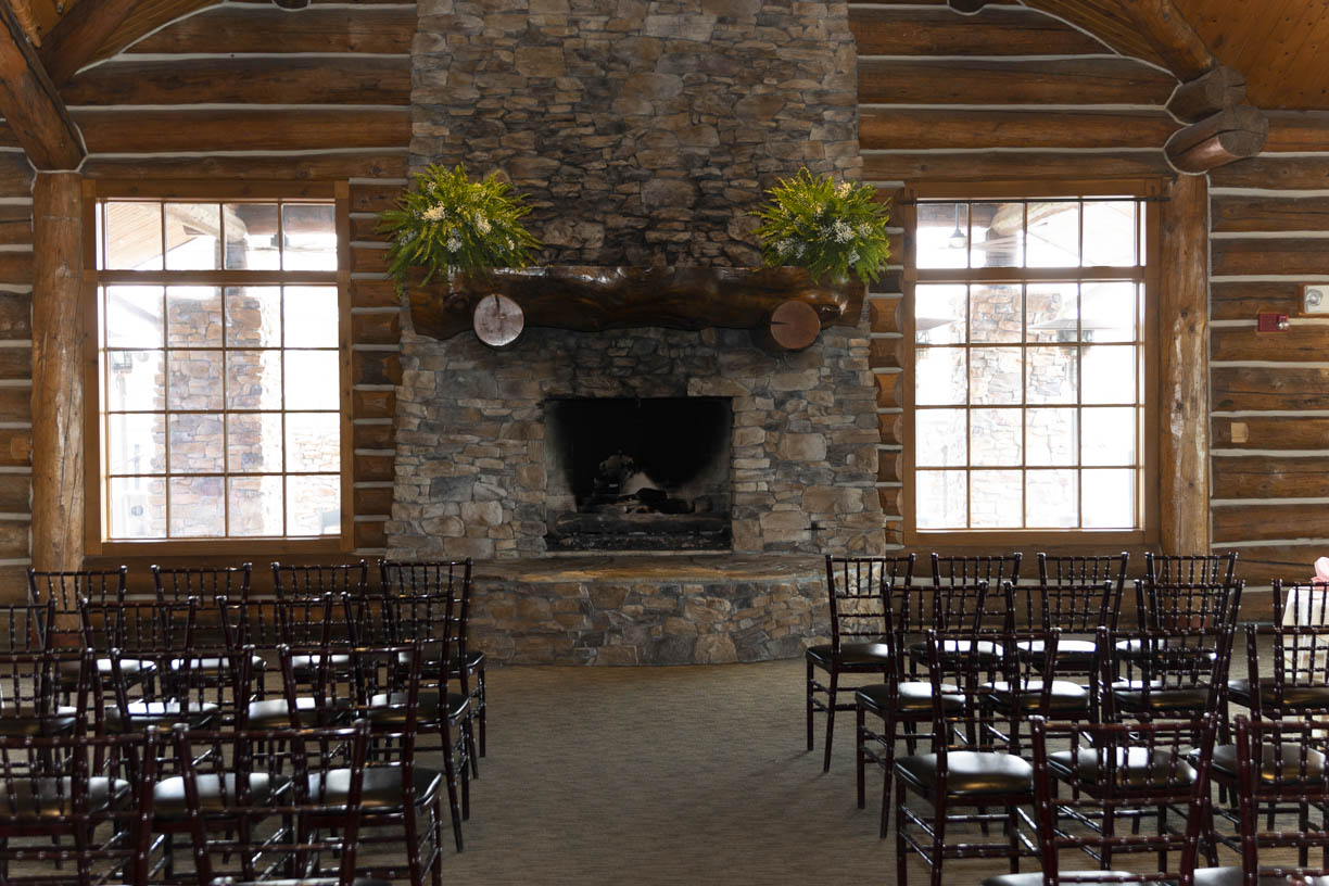 Details of a wedding ceremony set up in front of a stone fireplace