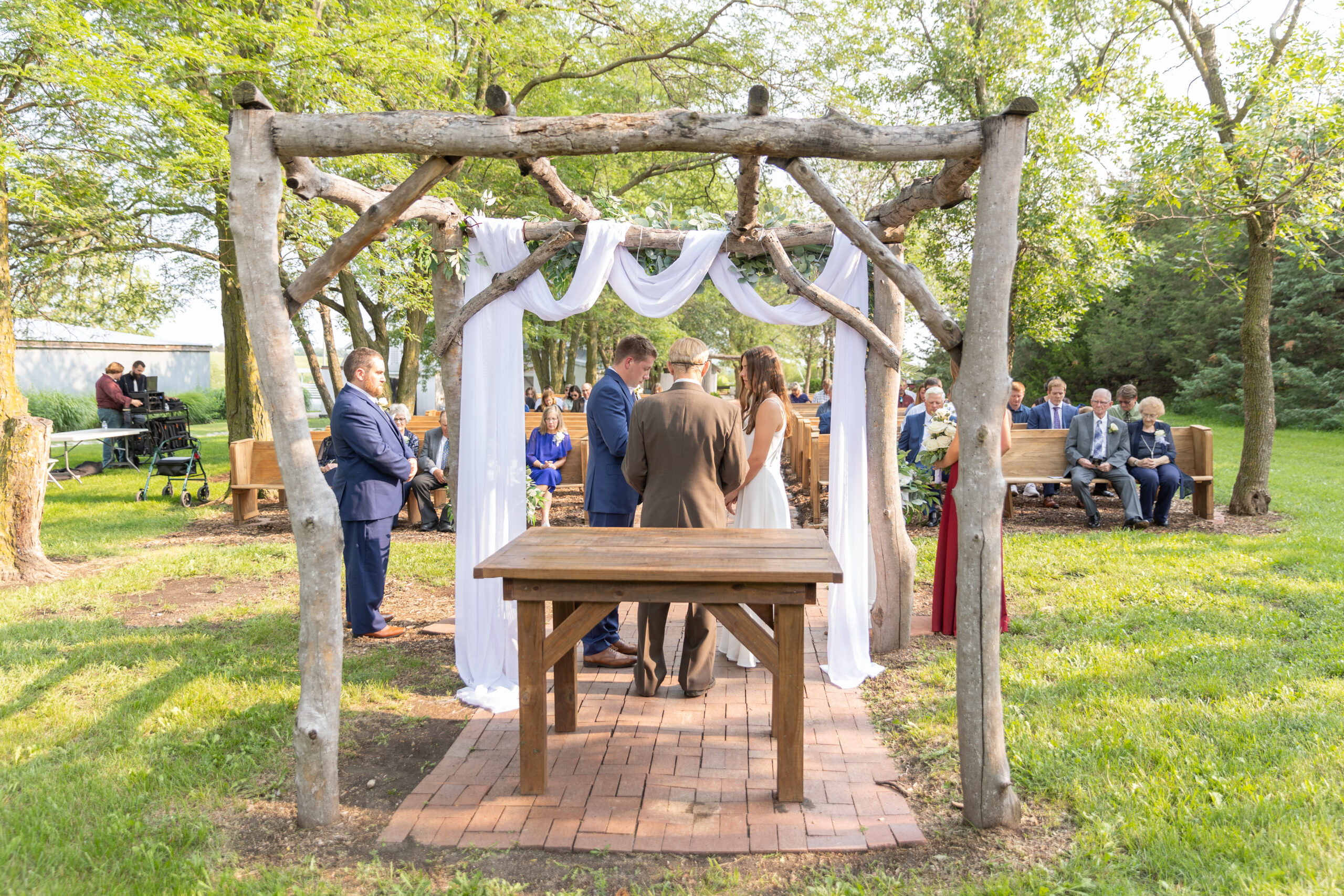Couple gets married under wooden alter