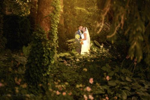 bride and groom surrounded by foliage