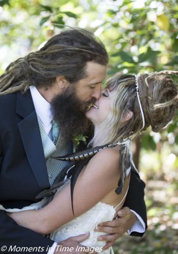 Jenny and Tyler kiss at their wedding
