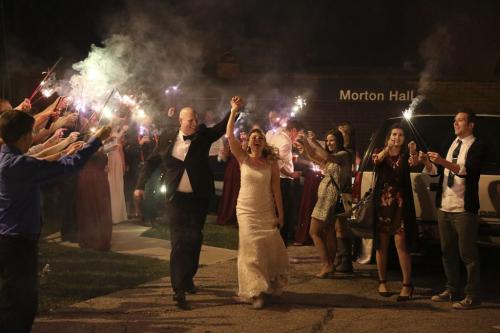 Bride and groom exit with sparklers after wedding.