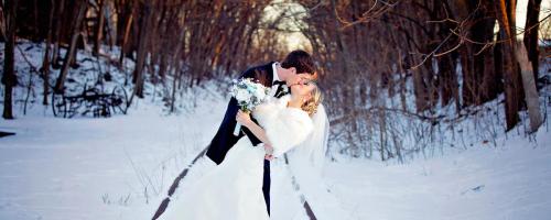 Groom dips bride in snowy weather